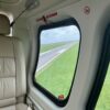 Looking out of a helicopter window as it enters the runway